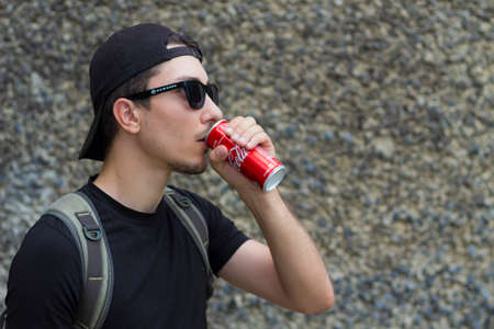 Kiev, Ukraine May 30, 2019 tourist in travel drinks Coca Colaのeditorial素材