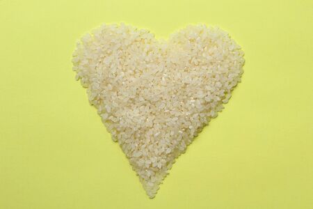 White rice in the shape of a heart, abstract beautiful backgroundの写真素材