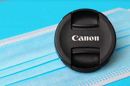 Balti Moldova May 7, 2020 Canon lens cap and medical surgical mask as a symbol of photographers in the lockdownのeditorial素材