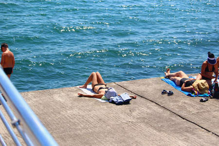 Odessa, Ukraine July 20, 2019, People on the city beach sunbathe in the midst of the tourist season . Editorial Use Onlyのeditorial素材