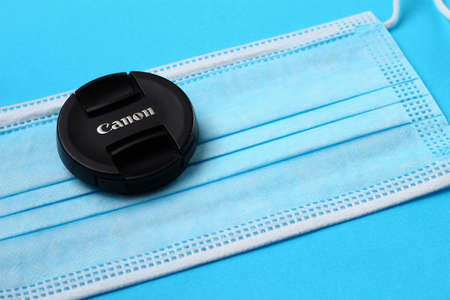 Balti Moldova May 7, 2020 Canon lens cap and medical surgical mask as a symbol of photographers in...