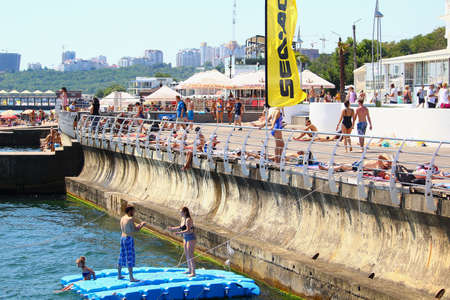 Odessa, Ukraine July 20, 2019, People on the city beach sunbathe in the midst of the tourist season . Editorial Use Onlyのeditorial素材