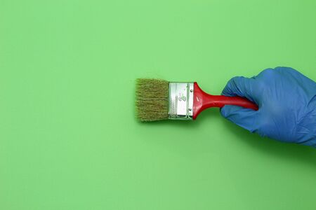 Light green wall and paint brush imitation. Home renovation design conceptの写真素材