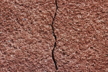 Large crack in the wall of the house, background