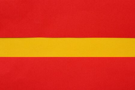 Abstract copyspace of yellow on a red background made from sheets of colored paper. Backgroundの写真素材
