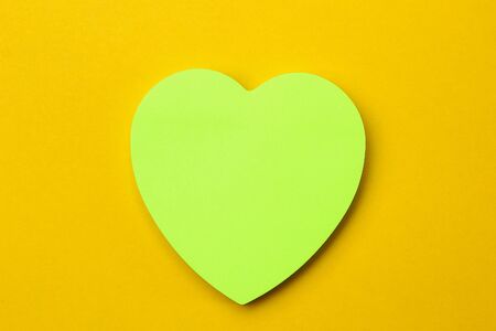 Blank sticker in the shape of a heart with copyspace for writing text or lettering. Background