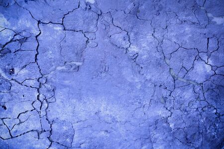 Texture cracked stucco on the wall in deep blue, a modern trend in advertising and design. Place in the middle for textの写真素材