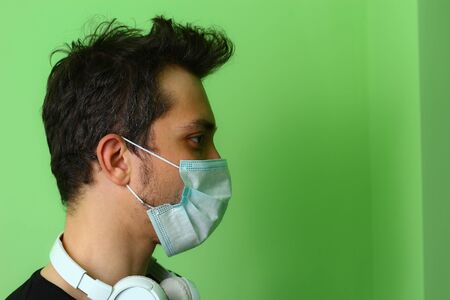Close-up face of a young man in a surgical medical mask