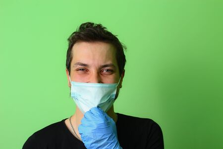 Expressive young man or guy on a light green background. The emotion of happiness and joyの写真素材
