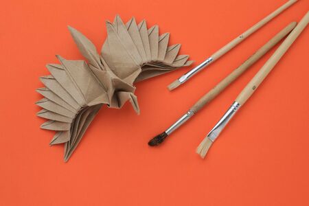 Origami paper bird mockup. Selective focus. Paint brushesの写真素材