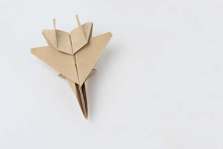 Origami paper airplane mockup. Selective focus. Light backgroundの写真素材