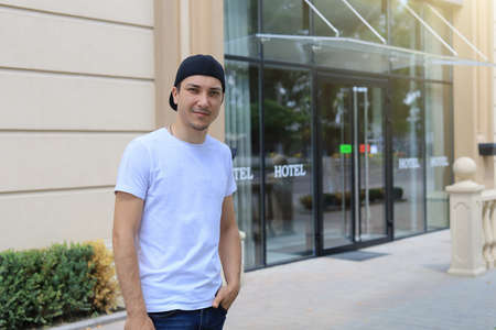 Young European man or white guy in a black mask on a blurred background of the urban environment, tonedの写真素材
