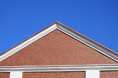 Classic slope of the roof of a brick house. Symbolic and conceptual background with copyspace for...