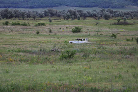 Military range for target shooting, body from a former car in an open field.