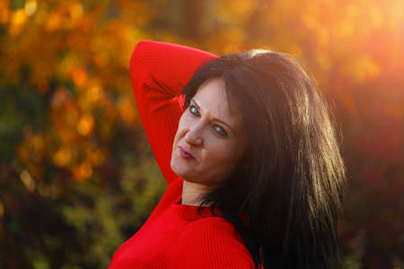 Young white woman or young adult Caucasian girl enjoys the solitude and unity with nature in autumn...