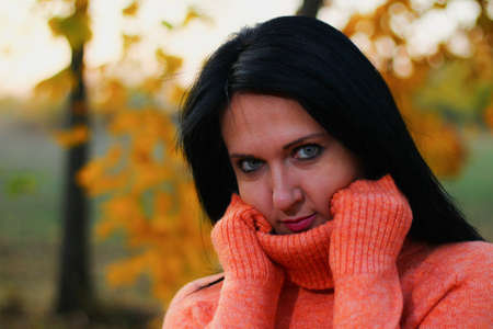 Young white woman or young adult Caucasian girl enjoys the solitude and unity with nature in autumn...