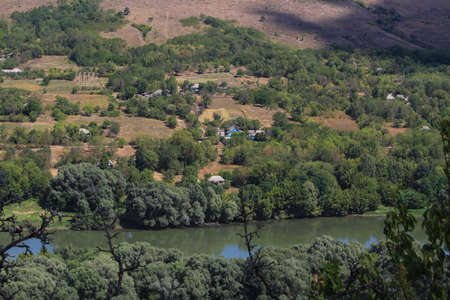 View of the river from a huge hill or mountain through the eyes of a hiker on a hike. Green forest...