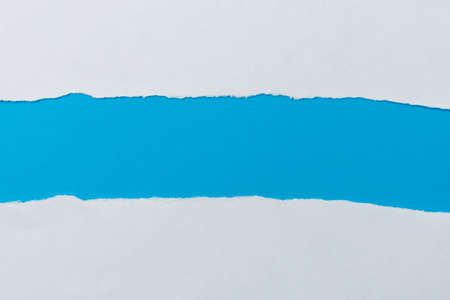 The torn paper forms an abstract background with copy space.