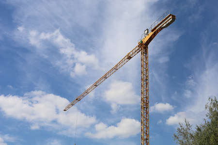 The crane on the background of a beautiful sky in good weather.