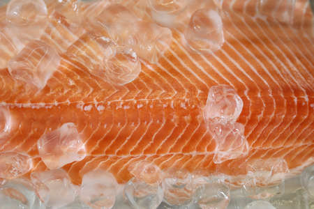 Fillet of red fish in ice. Cooking healthy diet food. Selective focus. Background