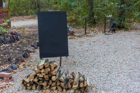 A clean black board for chalk and firewood for the barbecue. Blank for an inscription or text....