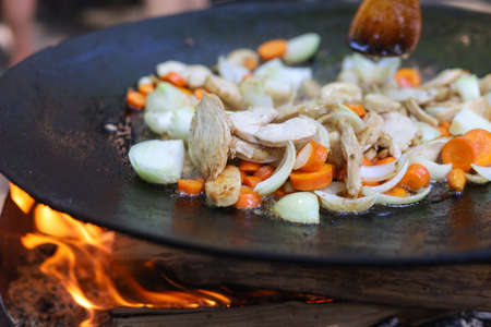 Chicken fillet and vegetables are fried on a disc. Selective focus. Blurred backgroundの写真素材