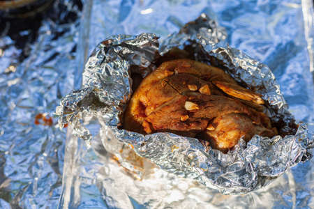 Pork knuckle baked in a tandoor. The shank is the part of a pork leg adjacent to the knee joint. Selective focus with blurred backgroundの写真素材