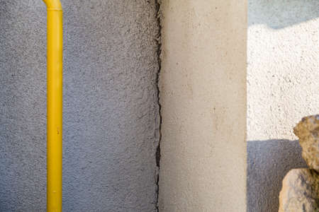 Old textured rough grunge wall with cracks. Background or graphic resource for design