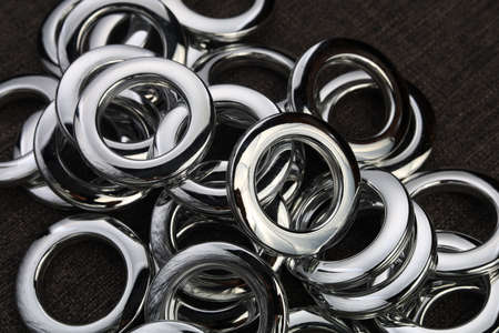 Glossy nickel-plated or chrome-plated Eyelets for attaching curtains in the design workshop....