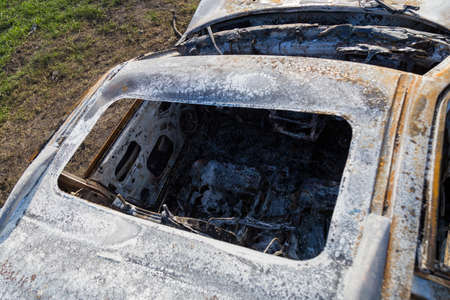 Burned down car, abstract background, selective focus. The situation of protests and pogroms in the world.の写真素材