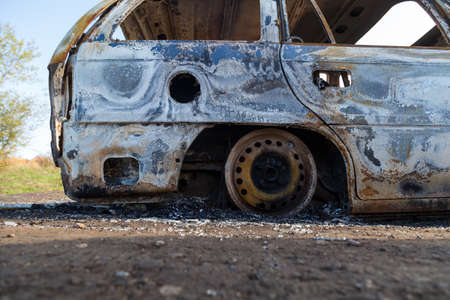 Burned down car, abstract background, selective focus. The situation of protests and pogroms in the world.の写真素材