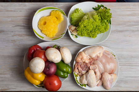 Pineapples, vegetables with mushrooms and chicken. Culinary background with selective focus and blurred background.の写真素材
