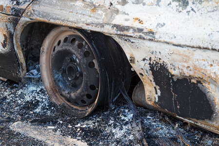 Burned down car, abstract background, selective focus. The situation of protests and pogroms in the world.の写真素材