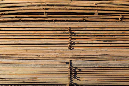 Wood planks for sale. Stacks of processed wood at the timber yard. Backgroundの写真素材