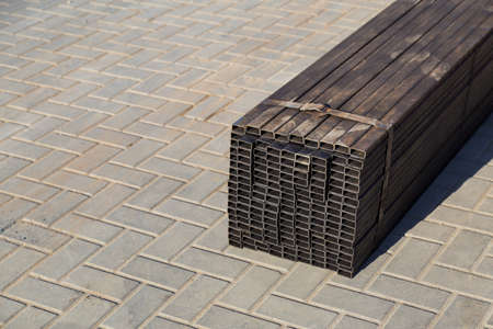 Rectangular metal pipes for building structures. Wholesale warehouse of a building base store. Backgroundの写真素材