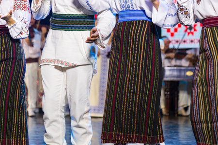 People in national authentic folk European costumes or clothing. Selective focus with blurred backgroundの写真素材