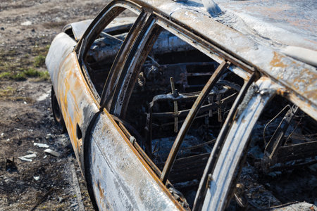 Burned down car, abstract background, selective focus. The situation of protests and pogroms in the world.の写真素材