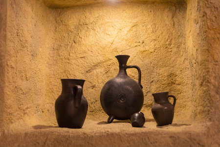 Antique pottery in a stone niche. Selective focus on blurred background.の写真素材