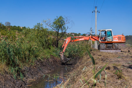 September 14, 2020 Balti or Beltsy Moldova works on deepening and cleaning the rainwater drainage channel. Illustrative editorial universal backgroundのeditorial素材