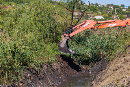 September 14, 2020 Balti or Beltsy Moldova works on deepening and cleaning the rainwater drainage channel. Illustrative editorial universal backgroundのeditorial素材