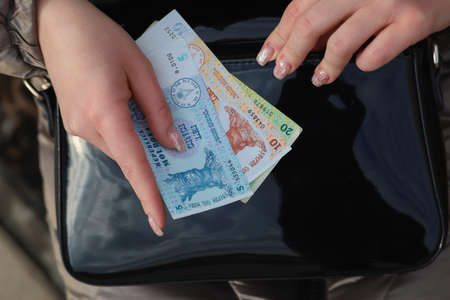 Womans hand and bill. Moldovan lei. MDL currency. Financial aid concept