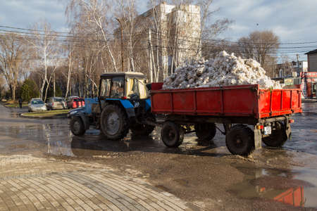4 February 2021 Balti Moldova tractor with a trailer removes snow from the city. Cleaning of the...