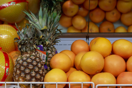 Pineapples and citruses on the counter. A department in a store or supermarket with fresh fruits and vegetables. Backgroundの写真素材