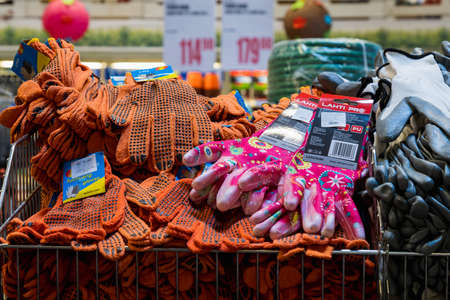 February 24, 2021 Balti Moldova. Huge supermarket, garden department. Showcase with gloves for work.
