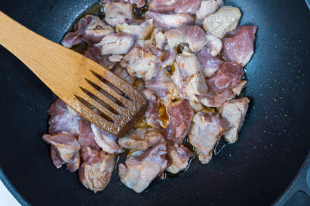 The process of roasting lamb in a pan. Home cooking or culinary background abstract. Homemade dish.の写真素材