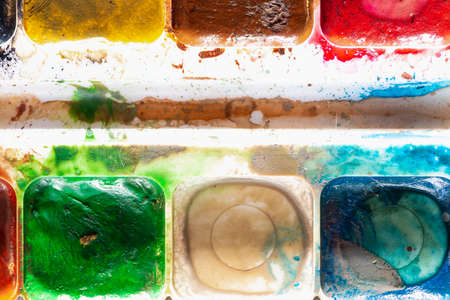 Used watercolor paint close-up. Creativity symbol. The concept of a completed project.の写真素材