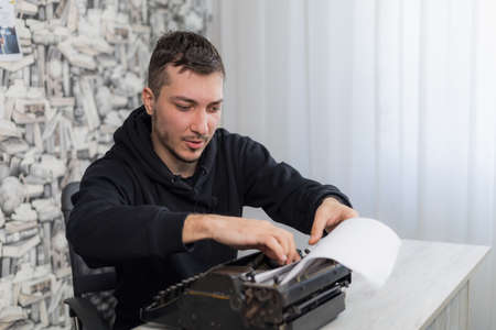 Young man or adult guy with a typewriter.の写真素材