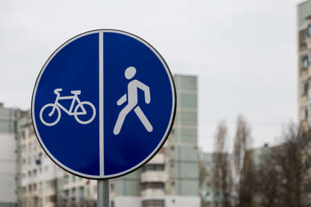 A road sign on the sidewalk indicating bicycle and footpaths. Background with place for textの写真素材