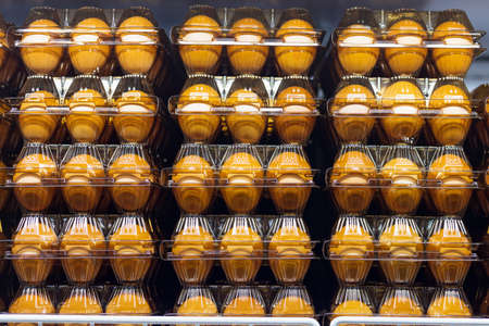 Product in a grocery store. Background with selective focus. Chicken eggs in disposable trays