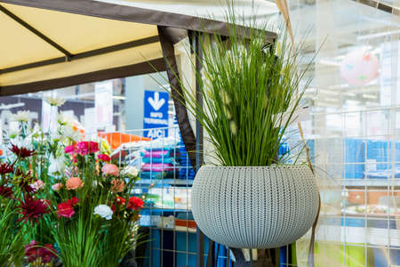 April 12, 2021 Beltsy, Moldova goods on the market shelf. Supermarket showcase. Illustrative editorial. Wicker pots for flowers on the outdoor terraceのeditorial素材